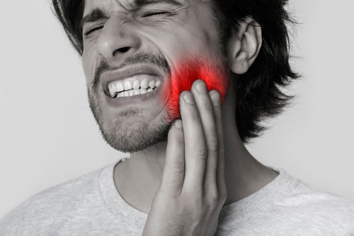 Man Suffering From Jaw Pain