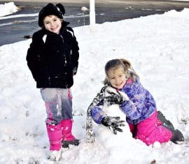Little girls playing in the snow