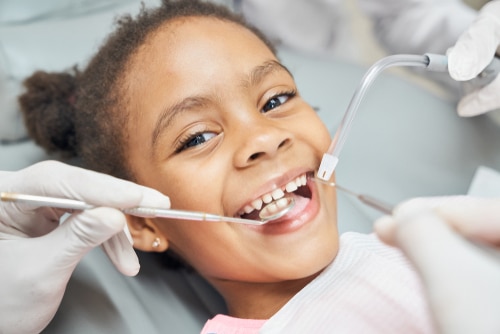 Little girl having here teeth cleaned