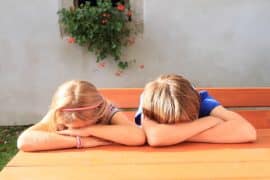 Tired kids with their heads on a table