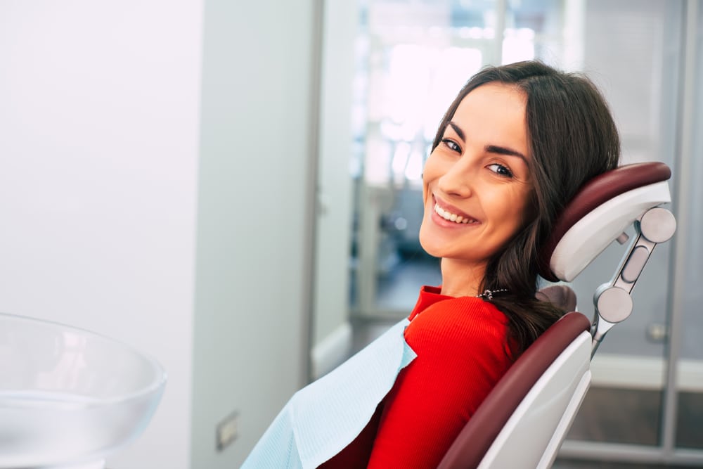 Happy patient in dental chair