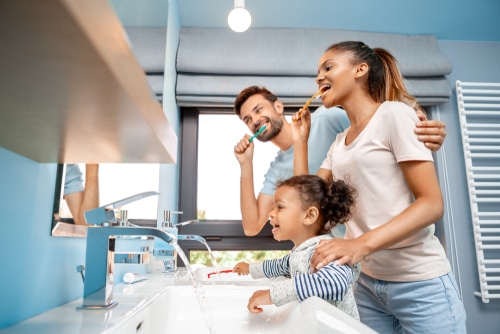 Happy family brushing their teeth