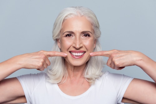 Woman pointing to her great teeth