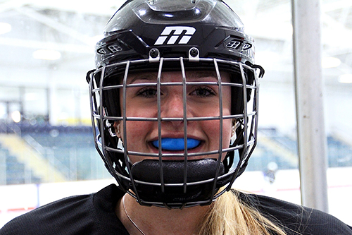 Young female hockey player with mouthgurad